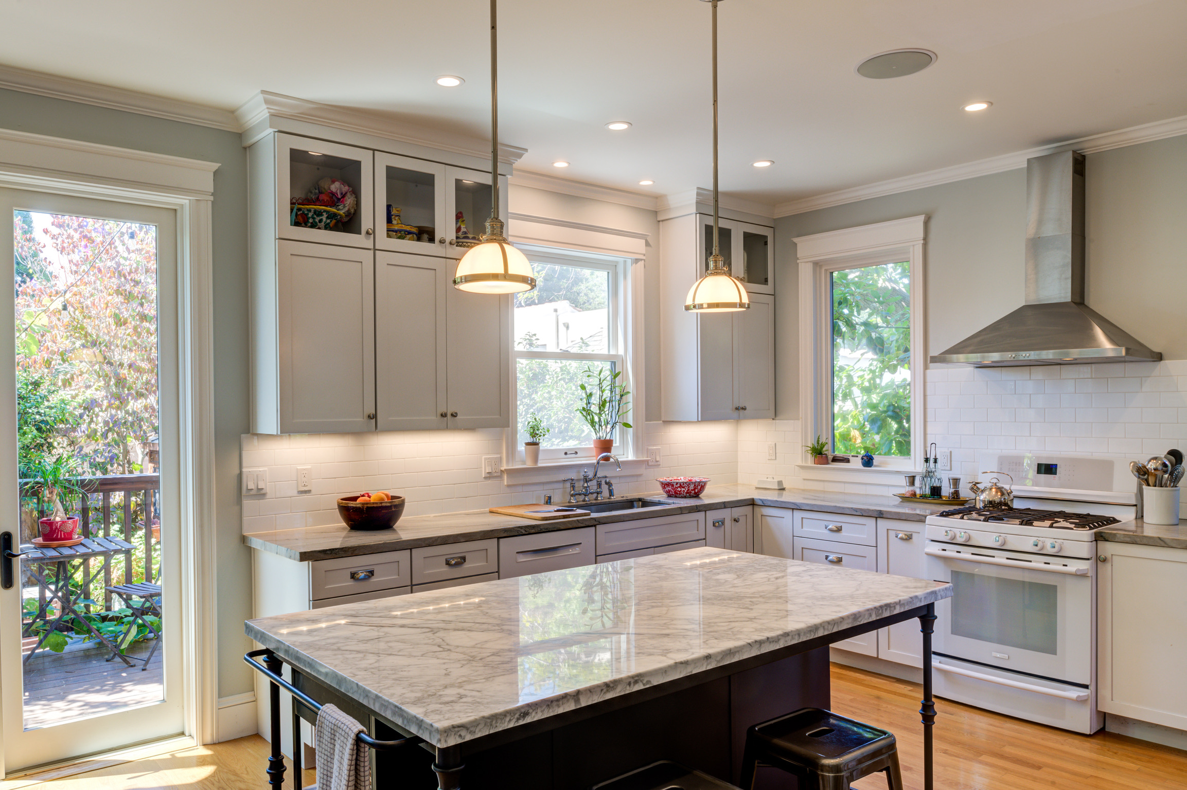 Kitchen layout features open flow, high-end appliances, quality island, remodel in Alameda Addition; ample natural light, deck access.