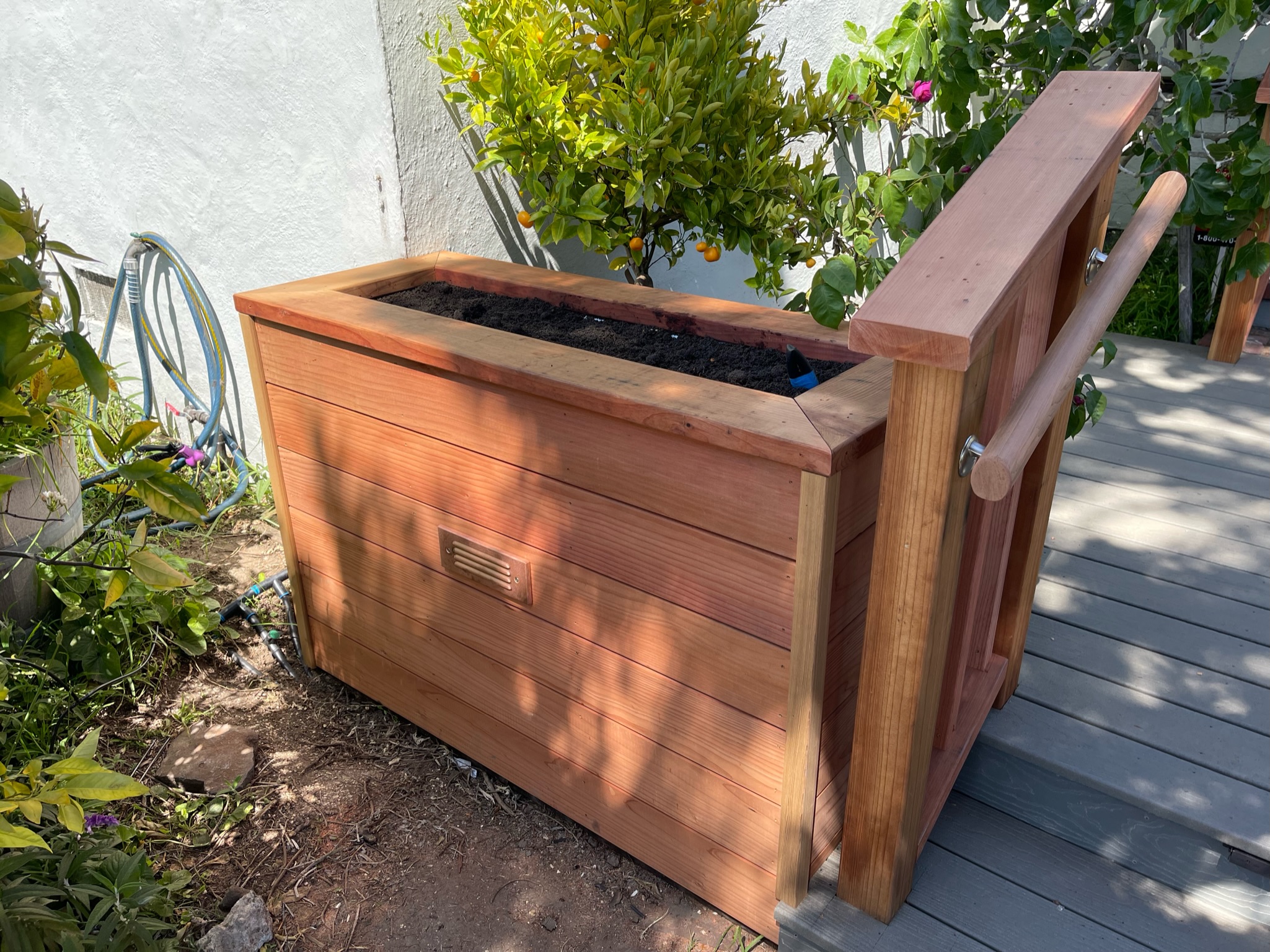 Raised garden bed placement on a front deck provides functional outdoor space for gardening and landscape enhancement opportunities.