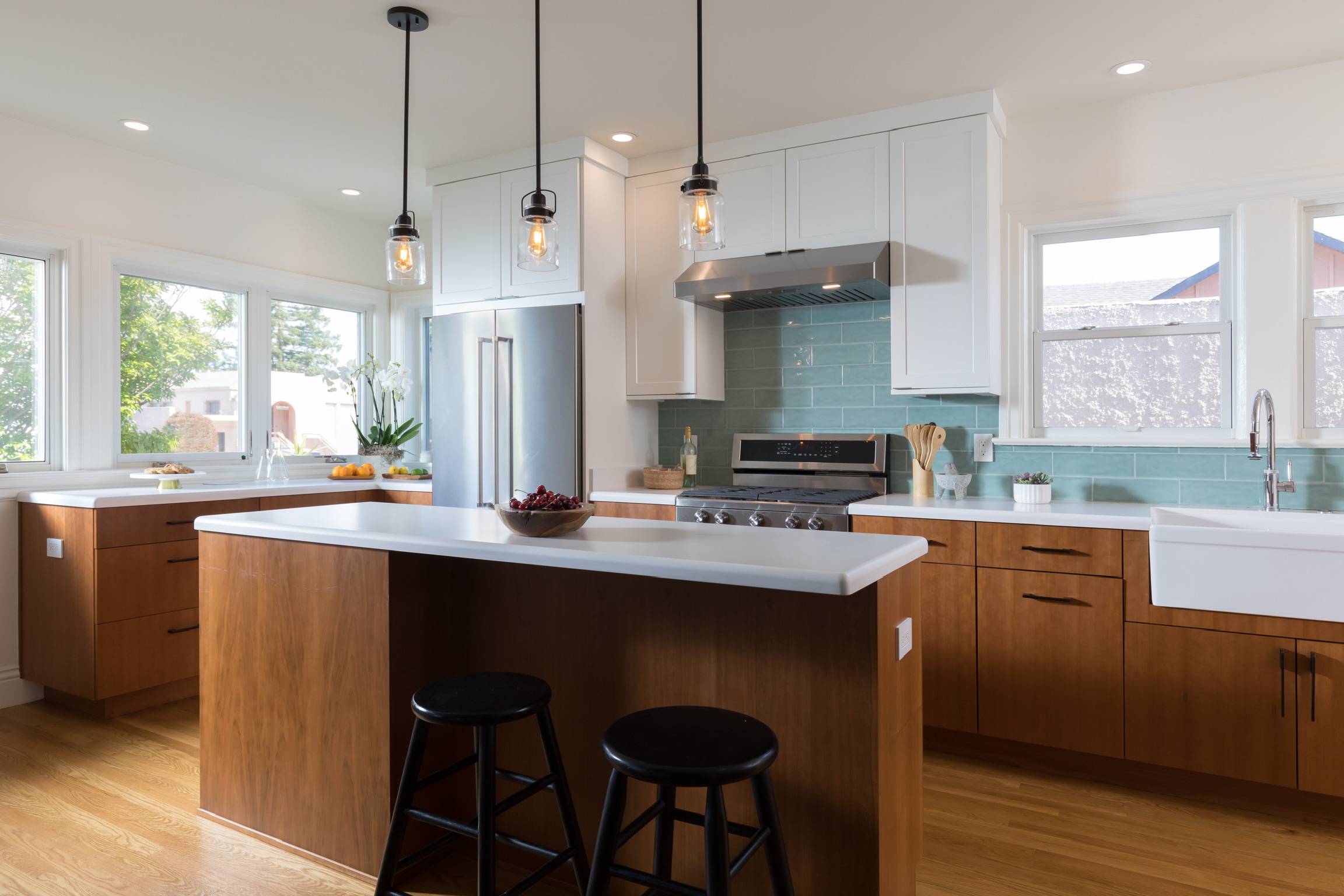 Modern Berkeley kitchen featuring updated cabinetry, contemporary surfaces, quality appliances, ample lighting, and large windows.