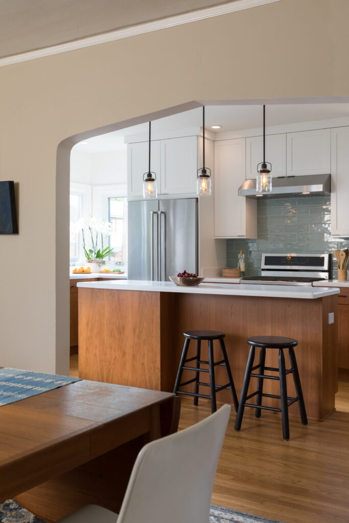 Modern Berkeley kitchen with open layout, updated appliances, central island, ample storage, and dining area connectivity.