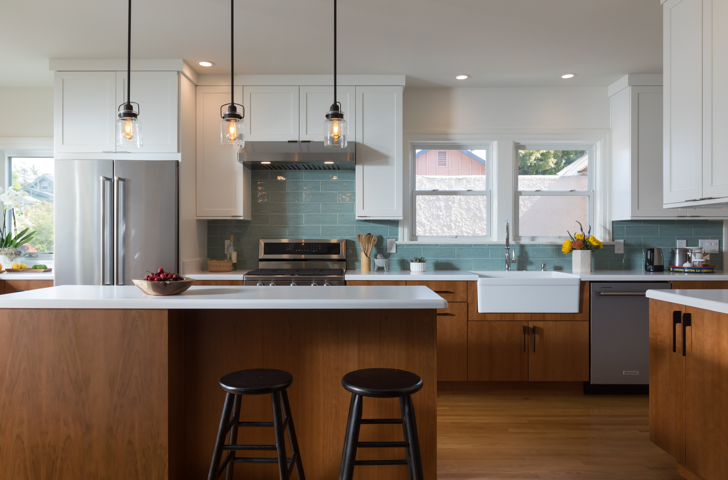 Modern Berkeley kitchen with updated cabinetry, open layout, island, high-end appliances, and ample natural light from dual windows.