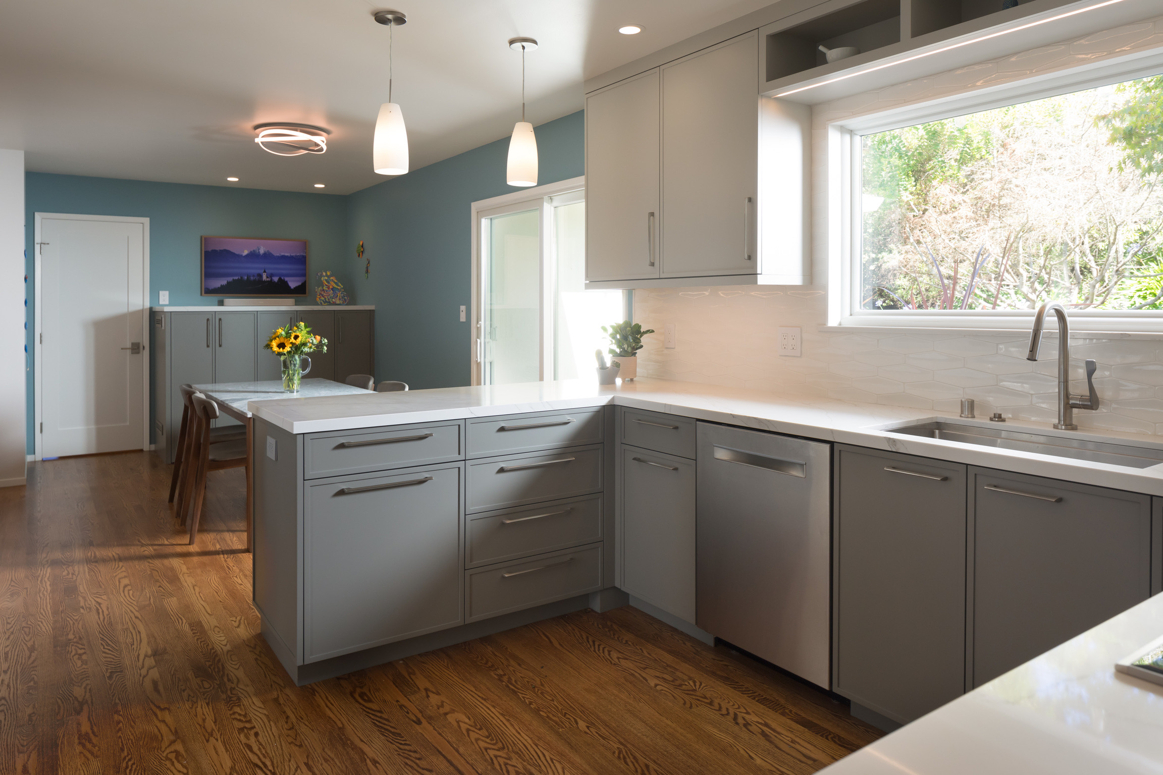 Modern El Cerrito kitchen features updated cabinetry, quality appliances, durable flooring, ample natural light from large window.