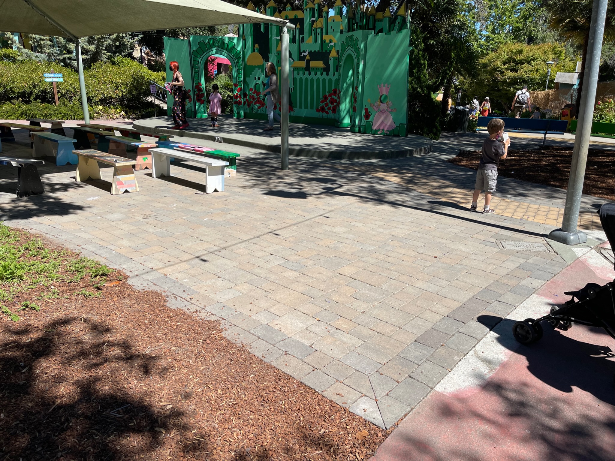 Spacious outdoor area with level ground, open sunlight, and a large backdrop structure—ideal for flexible redevelopment uses.