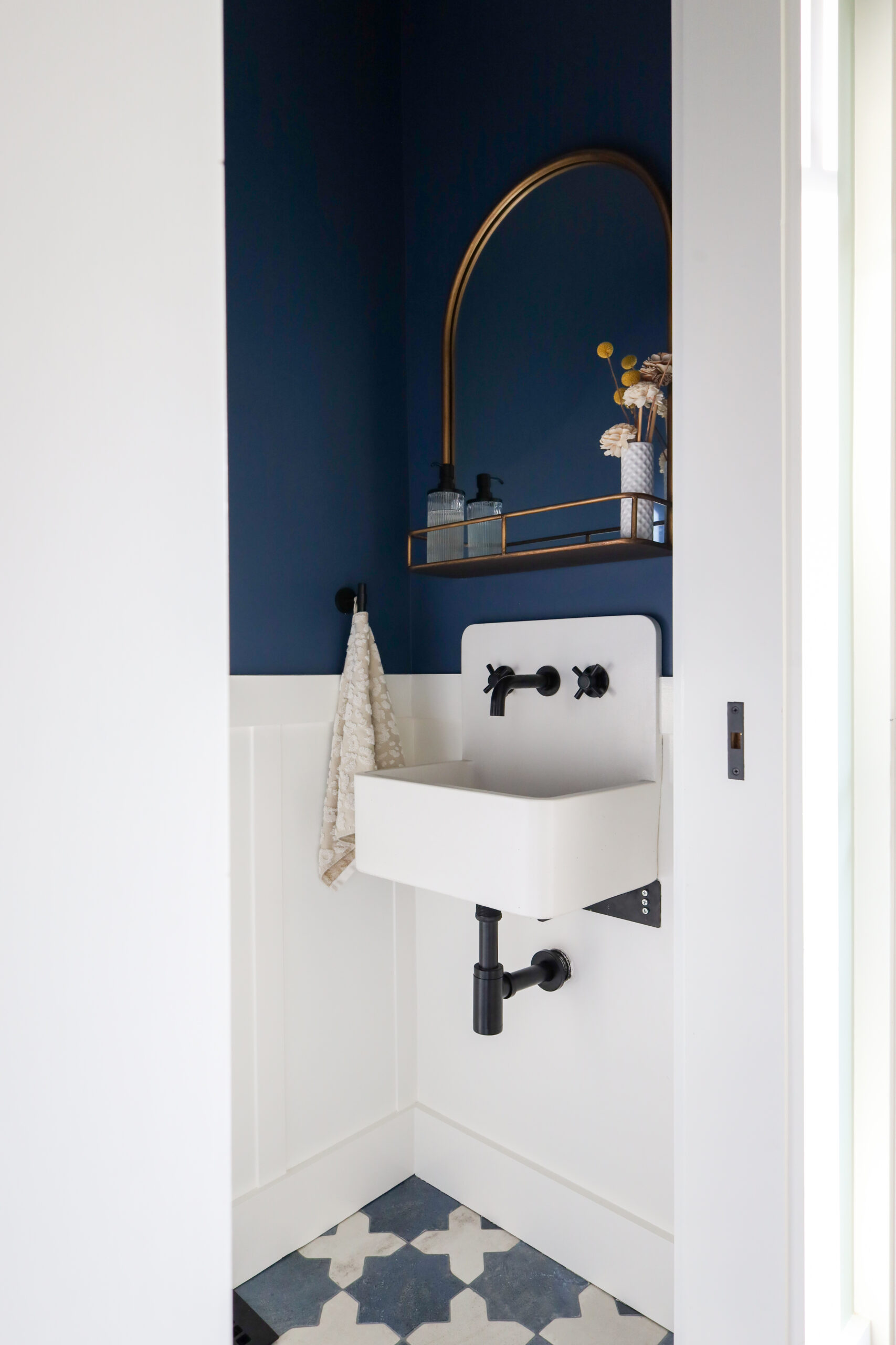 Compact bathroom layout featuring a space-saving wall-mounted sink, efficient fixtures, and built-in storage solutions.