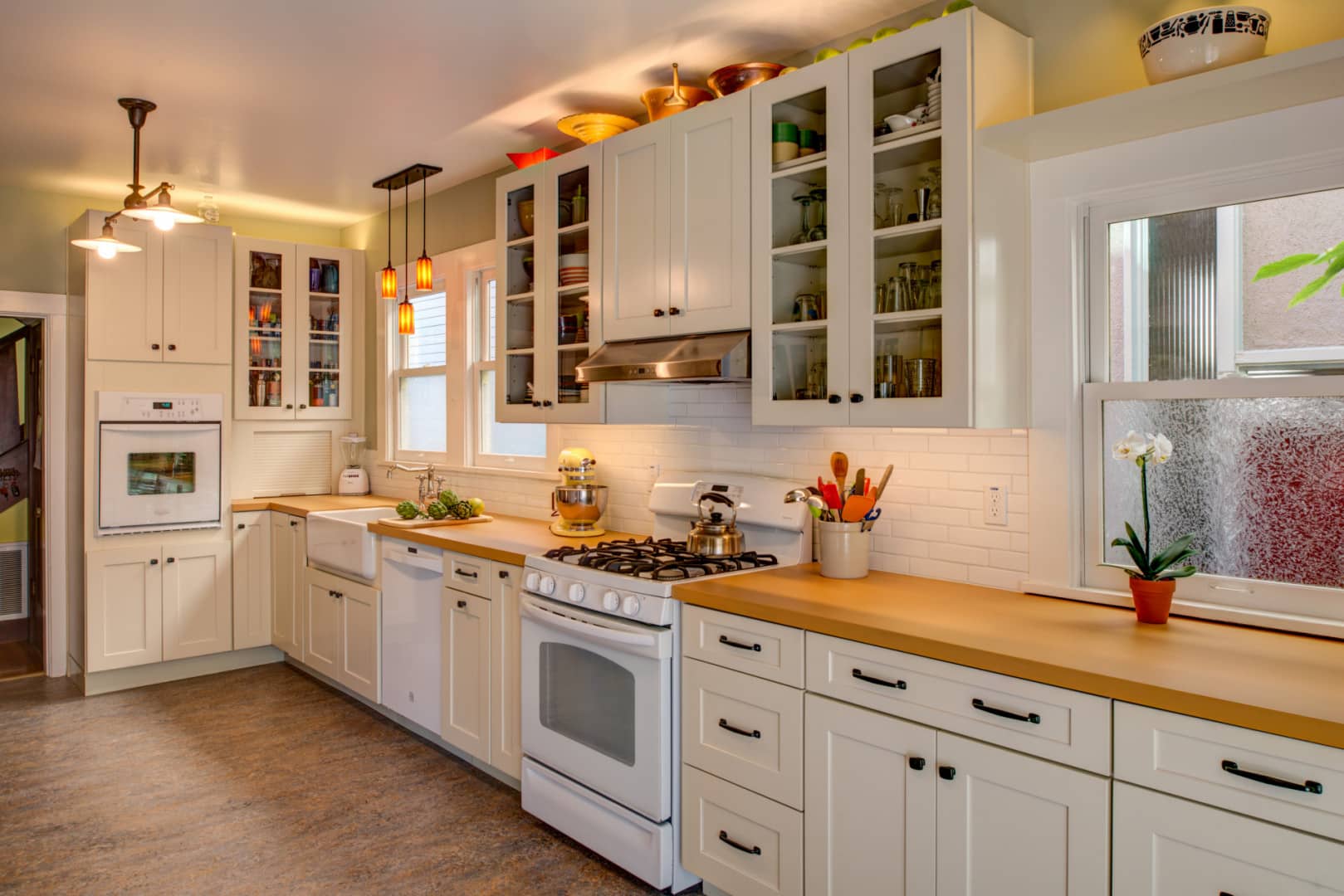 Spacious North Oakland kitchen with updated cabinetry, gas stove, built-in oven, modern tile backsplash, ample natural light.