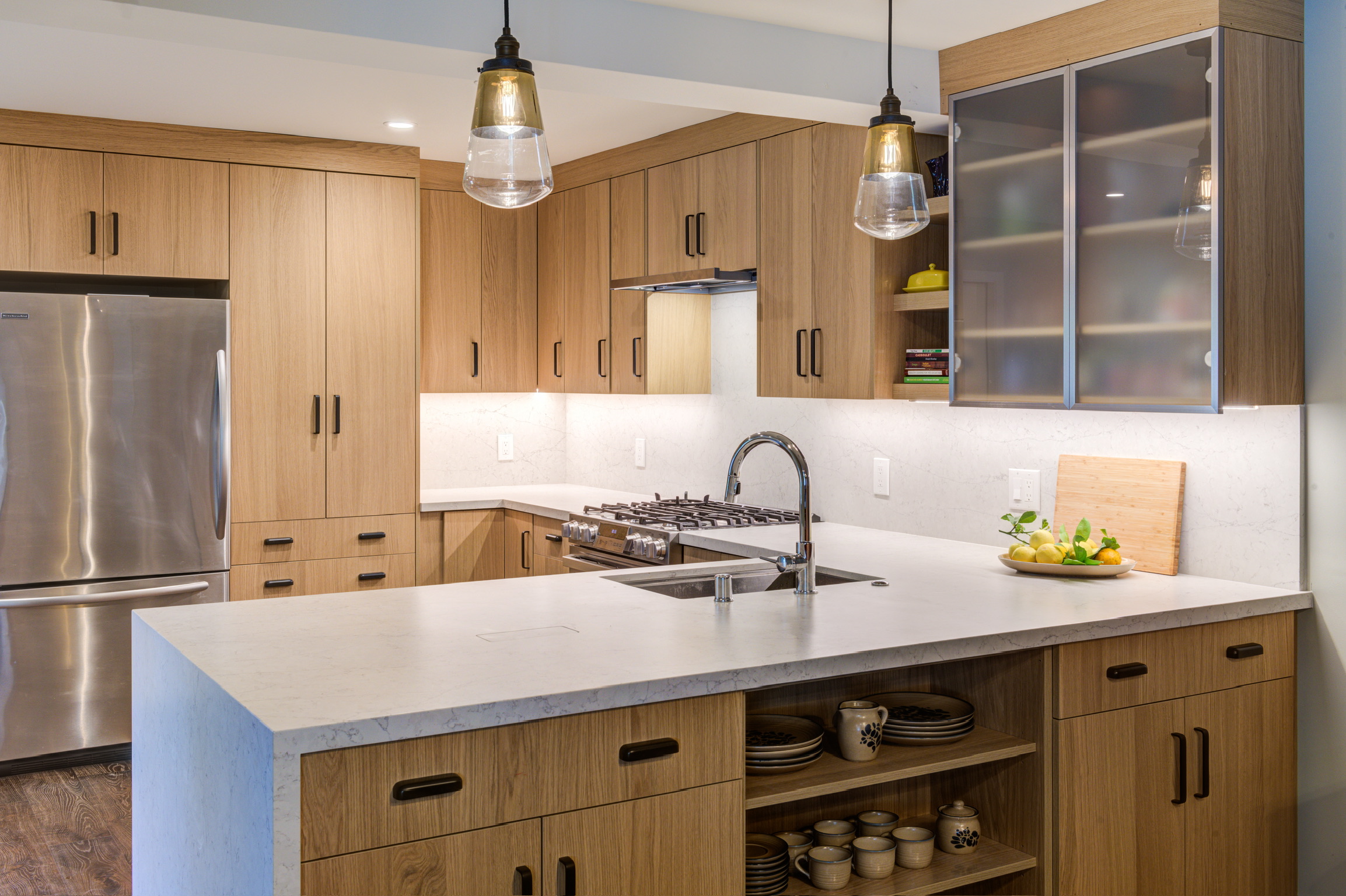 Modern kitchen layout with durable cabinets, updated appliances, open shelving, quality countertops, and functional lighting.