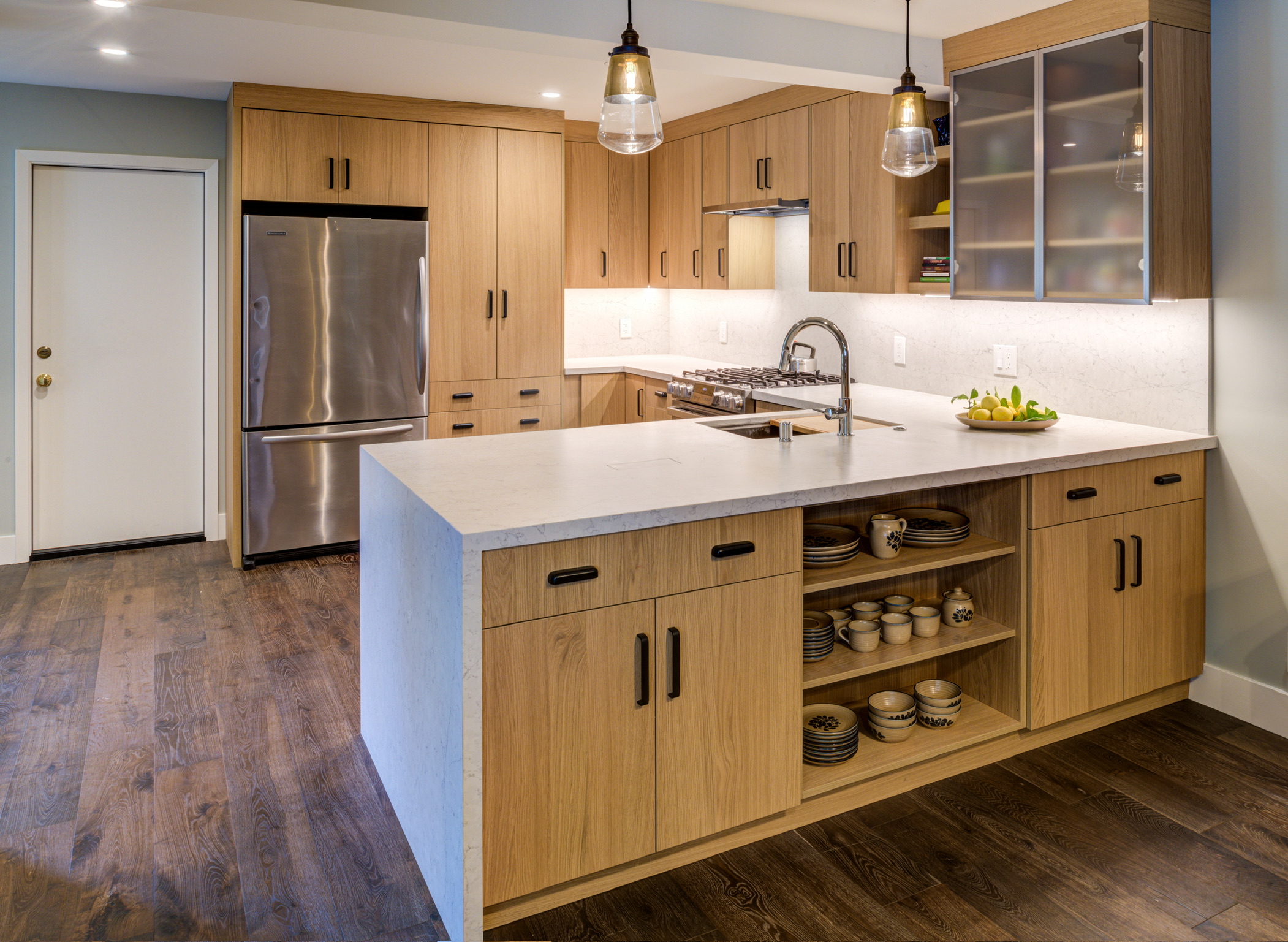 Contemporary Oakland Hills kitchen with modern layout, quality appliances, functional island, and open shelving for practical storage.