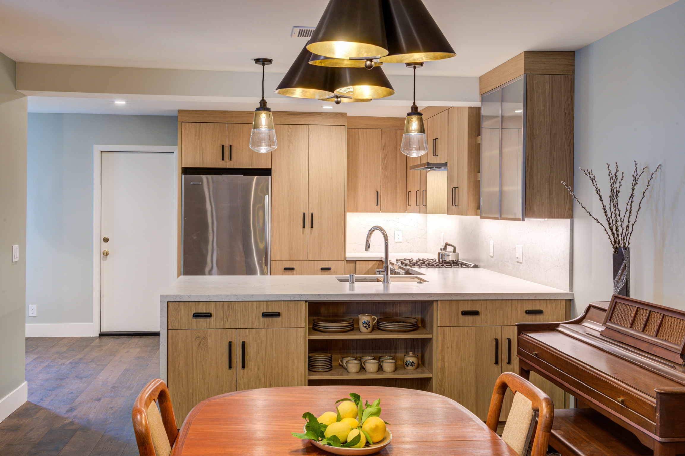 Modern kitchen layout with upgraded cabinetry, high-end appliances, durable countertops, efficient lighting, and open floor plan.
