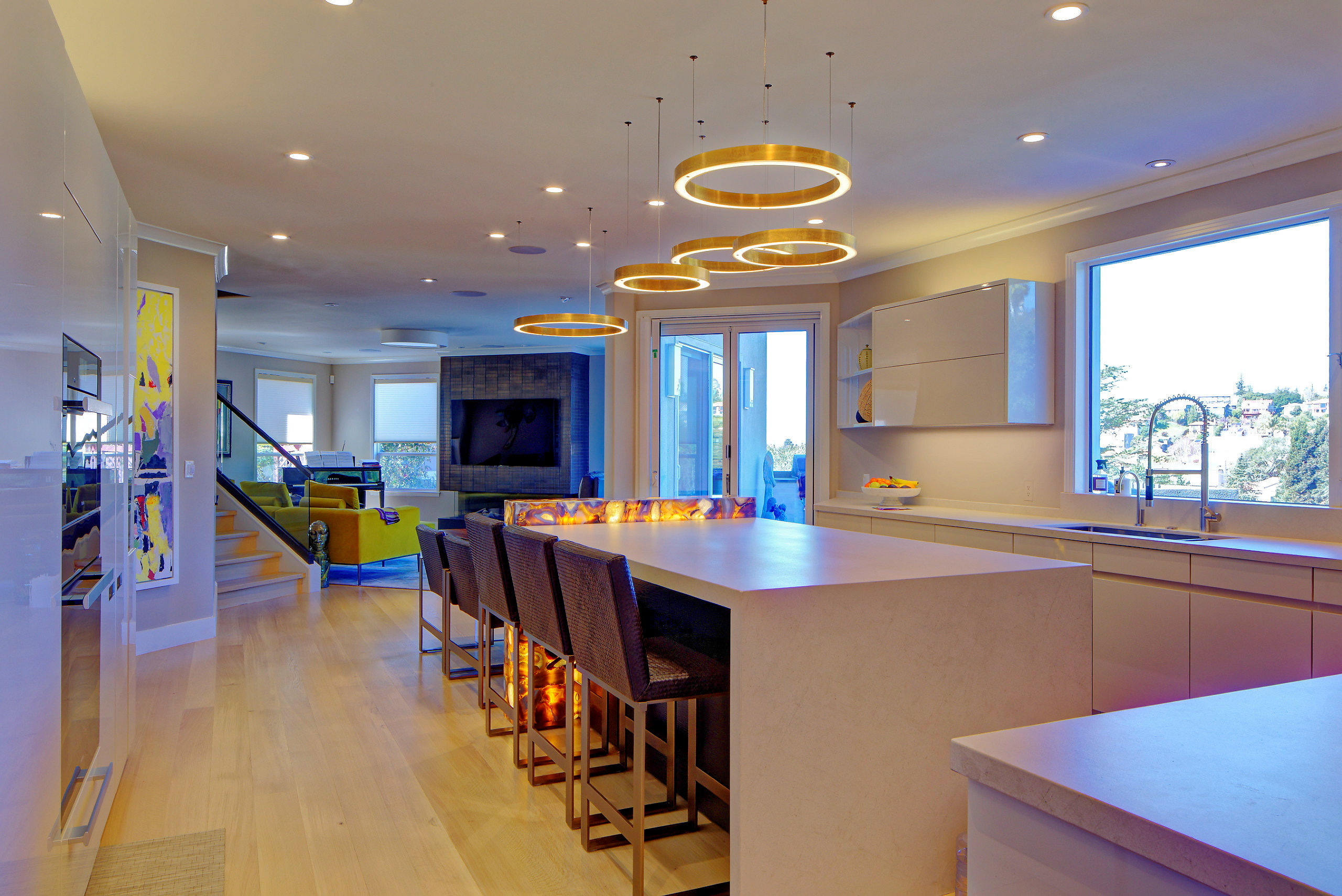 Contemporary kitchen with spacious island and open floor plan seamlessly merging with living area, ideal for renovation potential.