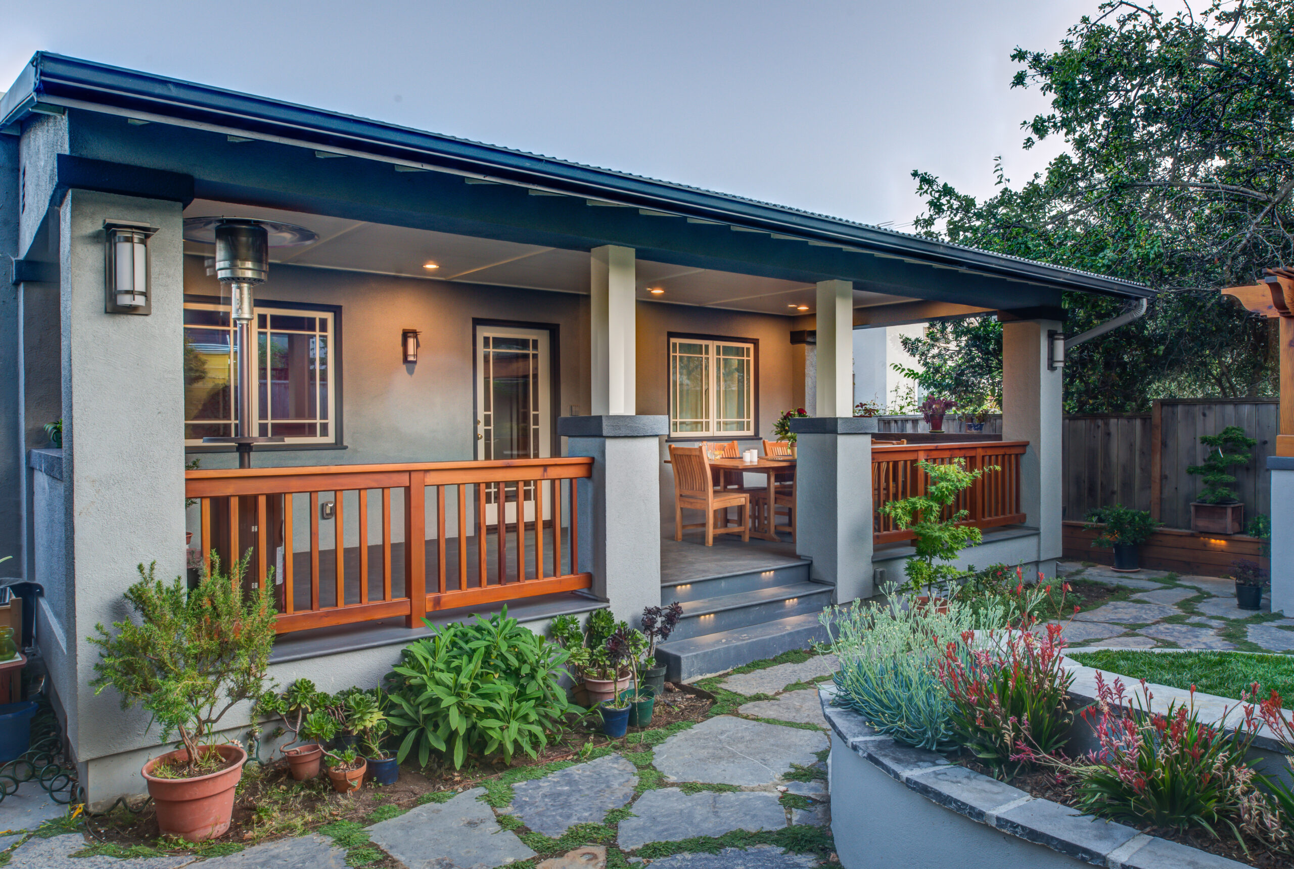 Backyard porch in Oakland with durable railings, stone steps, and garden area; layout suitable for expansion or upgrades.