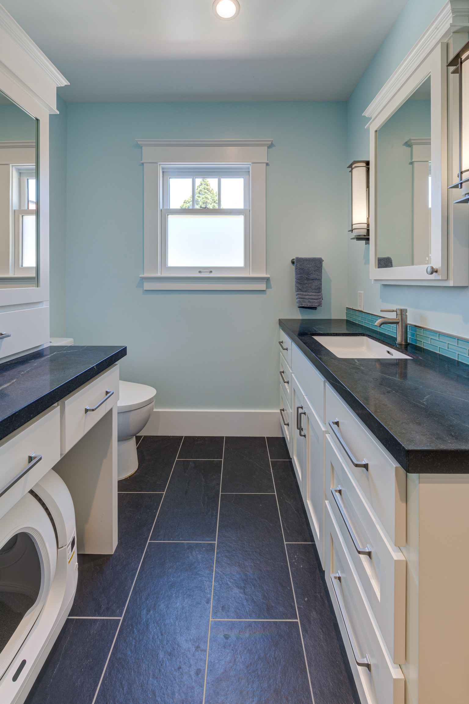 Oakland bathroom featuring laundry hookup, updated fixtures, practical layout, natural light, and Whole House living potential.