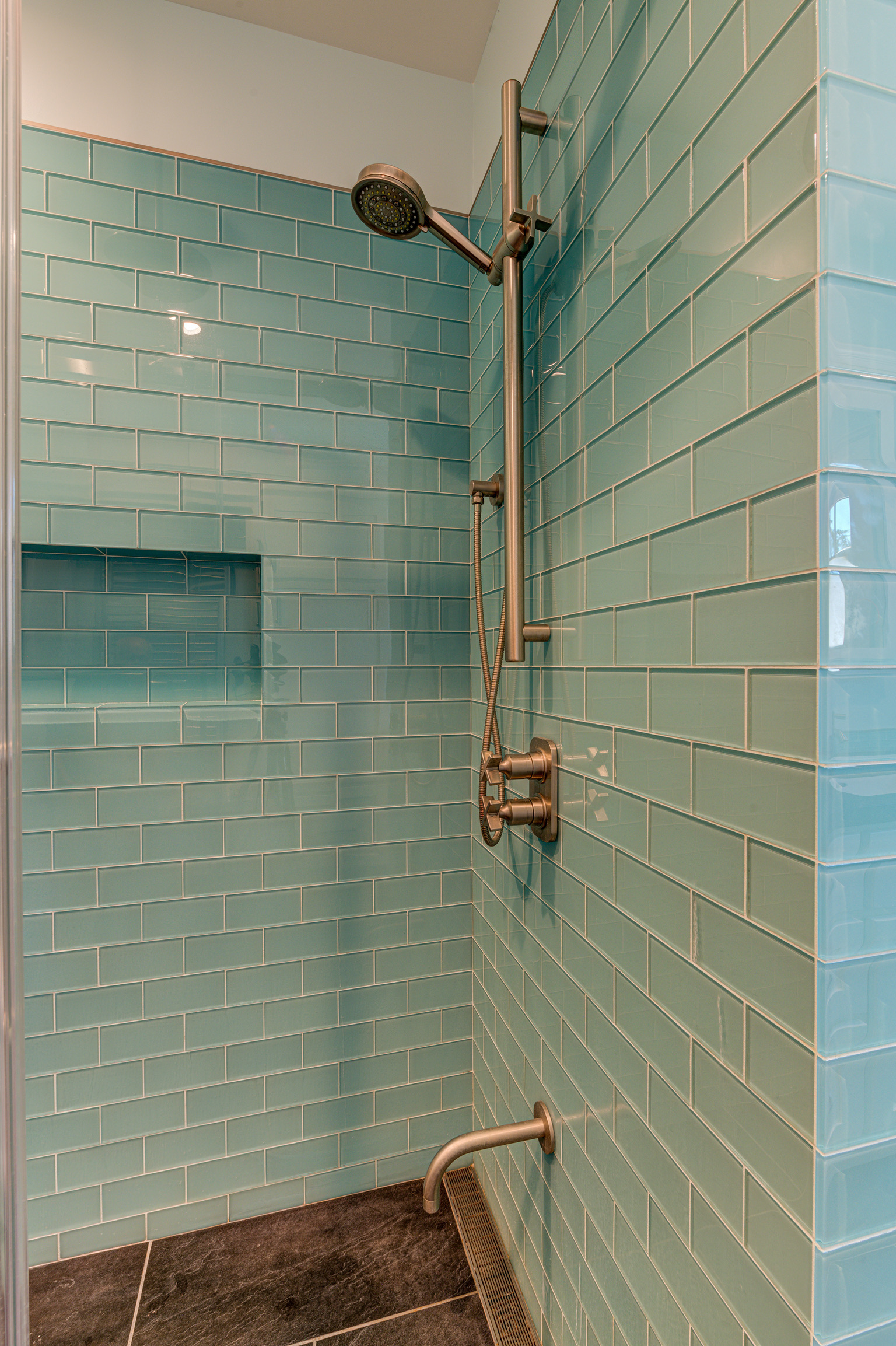 Oakland walk-in shower with durable tiled walls, modern fixtures, built-in storage niche, and easy-to-clean flooring—ideal for upgrades.