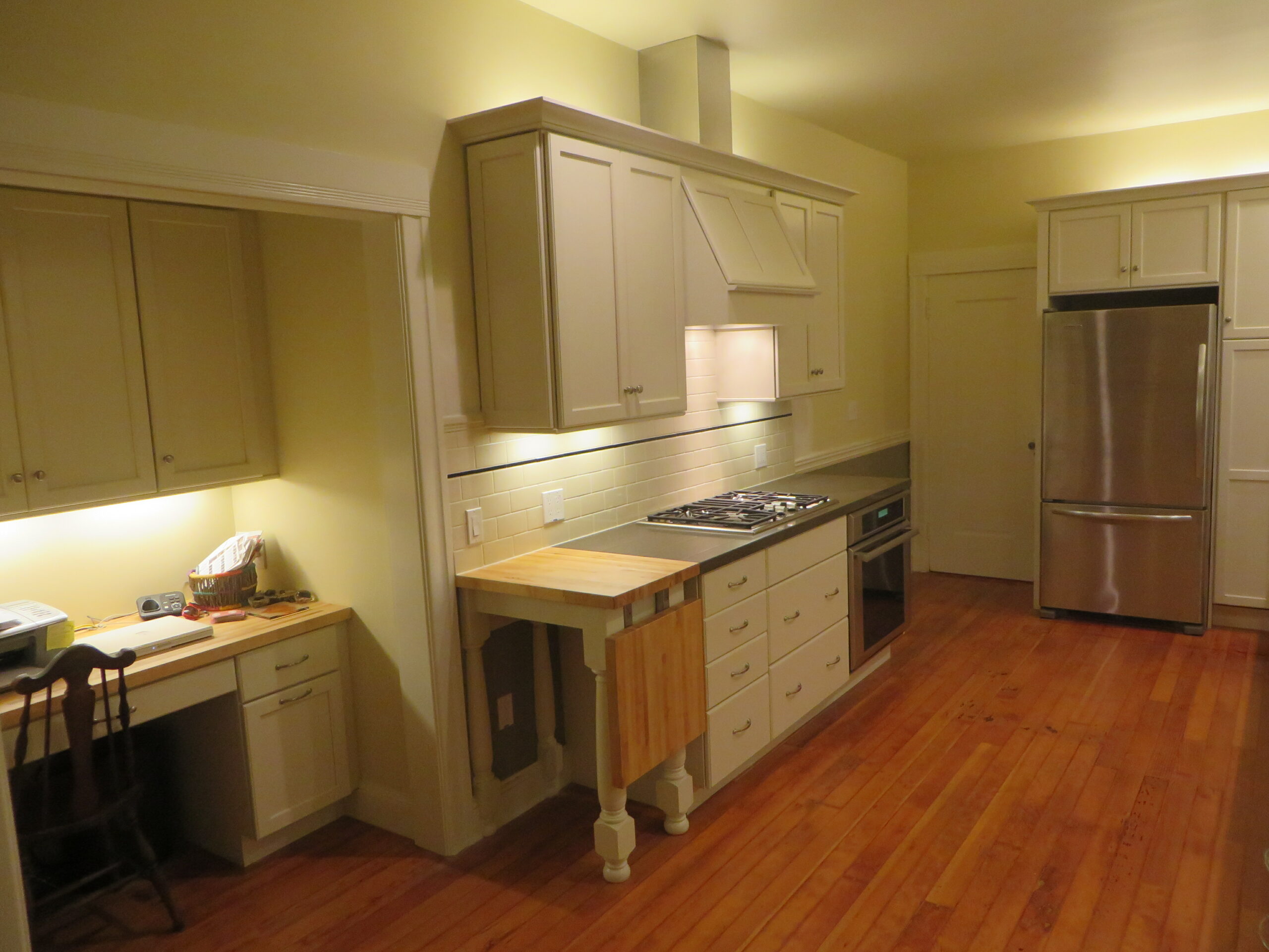 Piedmont kitchen with durable cabinetry, hardwood flooring, built-in workspace, and updated appliances ideal for renovation.