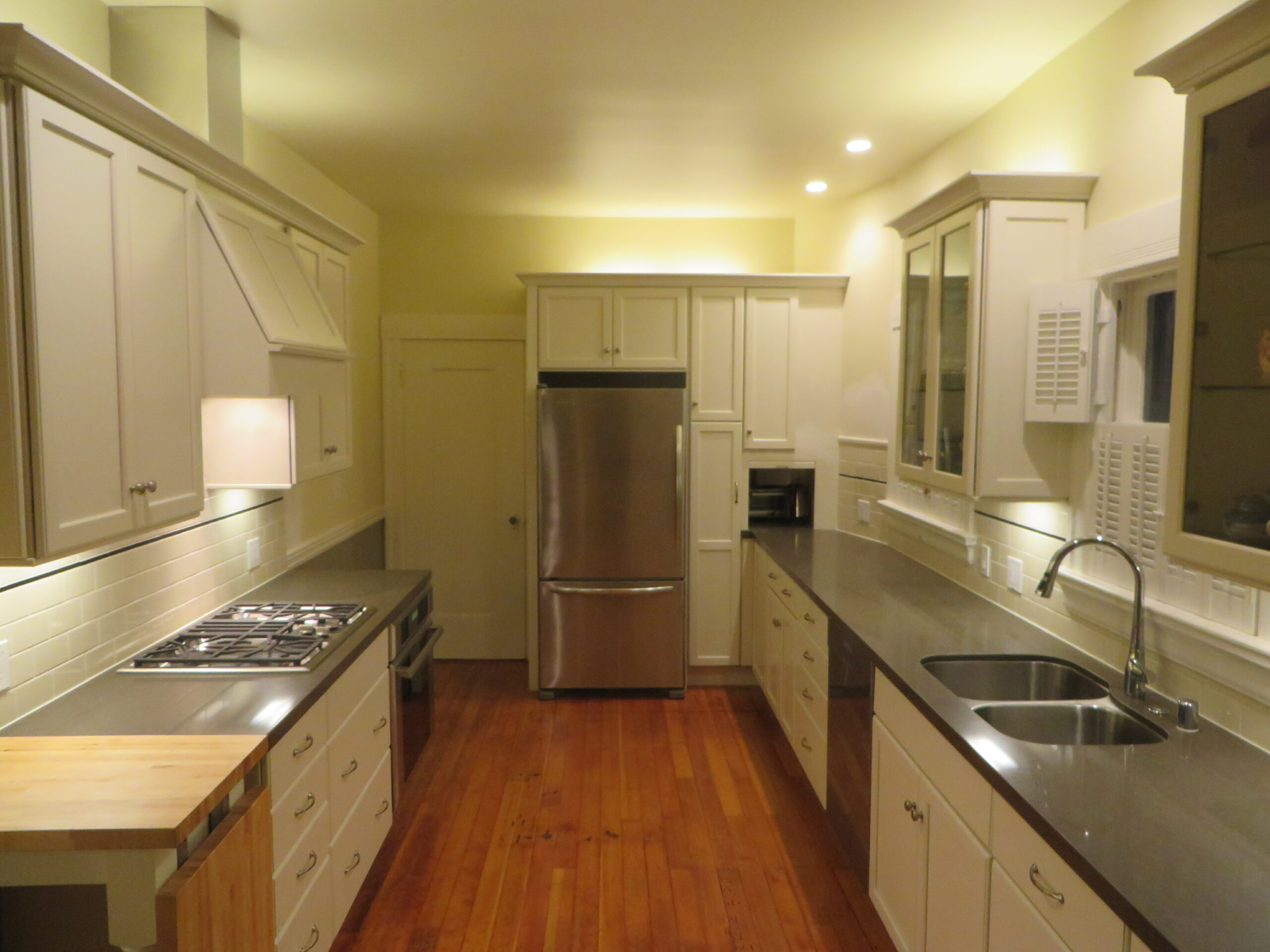 Modern Piedmont Kitchen with updated appliances, efficient layout, double sink, gas stove, and ample overhead lighting.