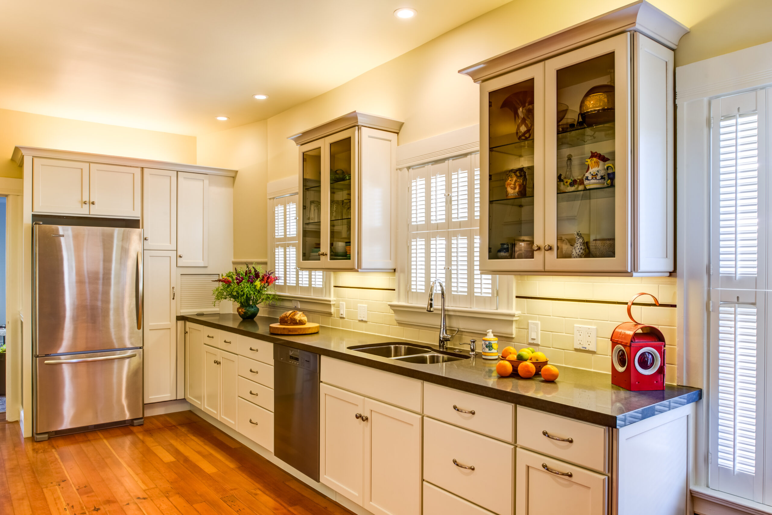 Spacious kitchen with remodeled layout, quality built-in appliances, ample natural light, modern surfaces, and updated flooring.