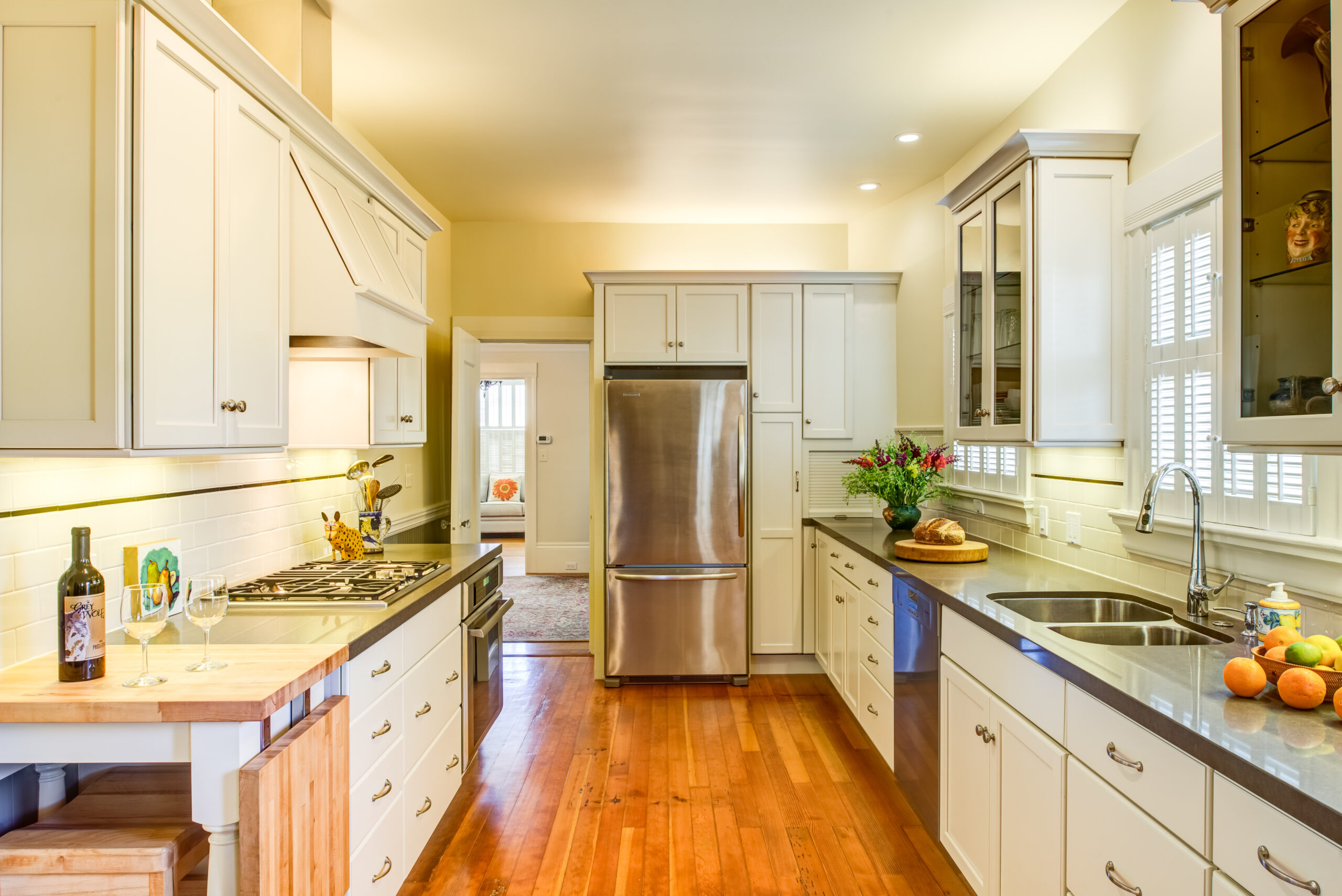 Spacious remodeled kitchen features updated appliances, double sink, modern layout, quality fixtures, and efficient workspace.