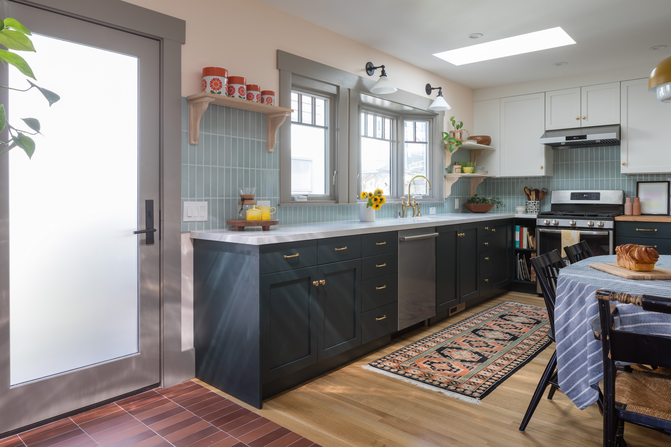 Modern West Berkeley Kitchen featuring durable cabinetry, tiled backsplash, open shelving, and updated stainless appliances.