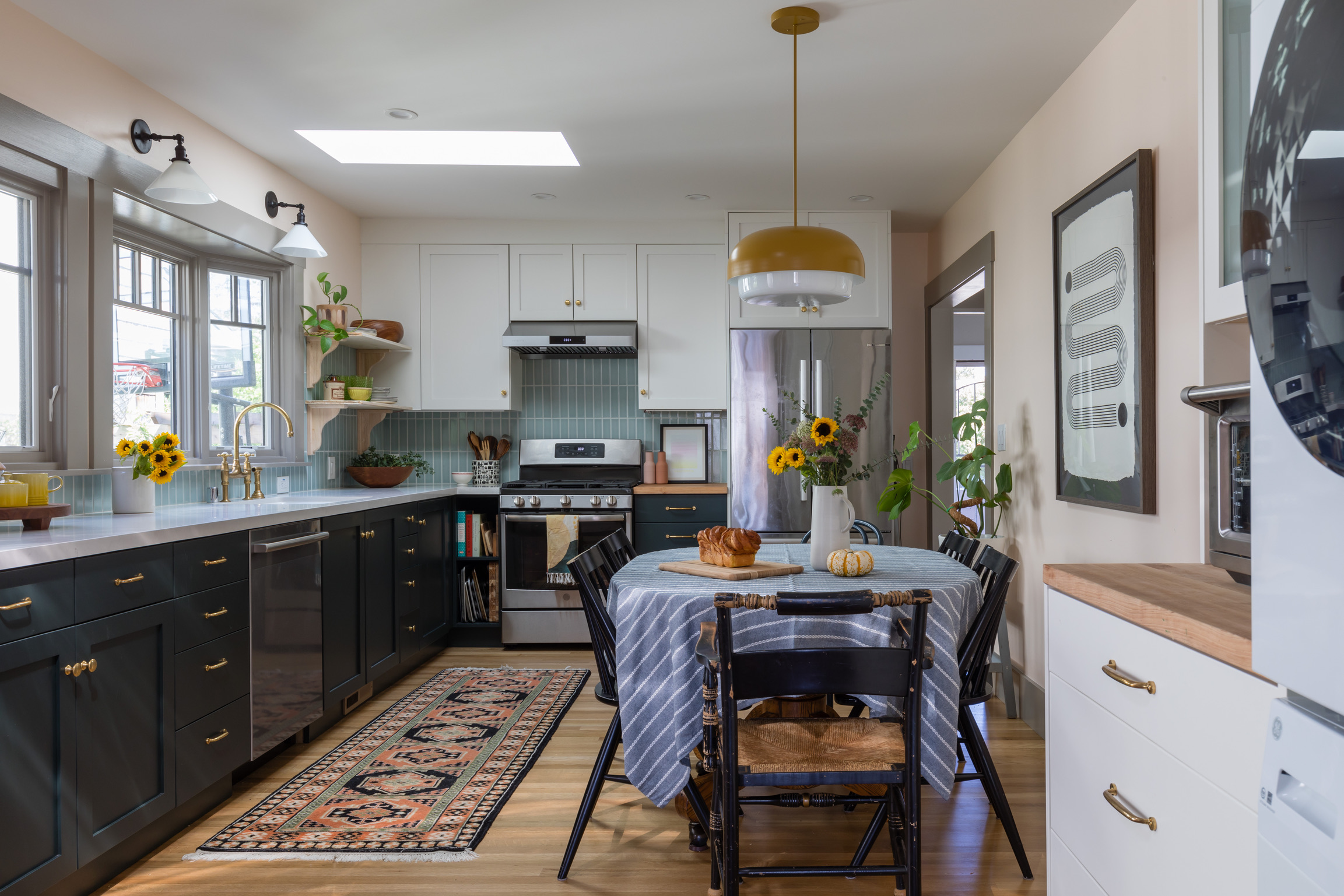 Modern West Berkeley Kitchen featuring mixed cabinetry, ample natural light from windows and skylight, and efficient layout.