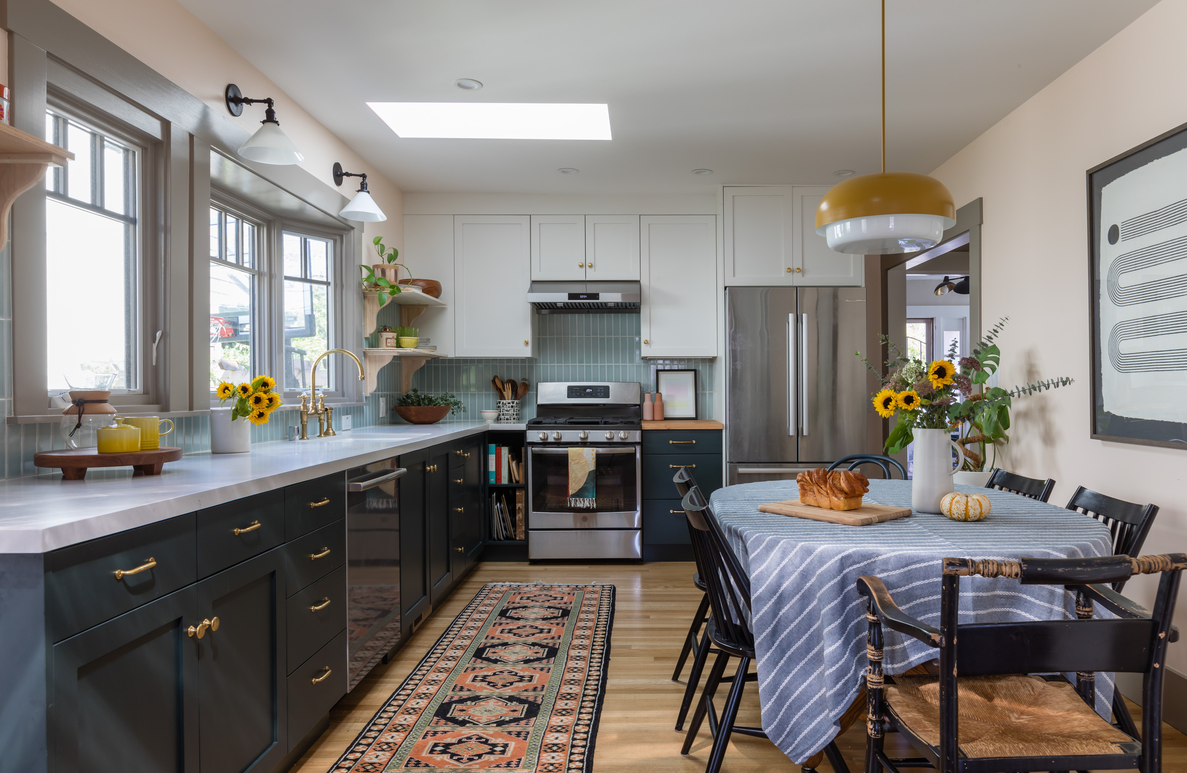 A renovated West Berkeley kitchen featuring upgraded cabinetry, modern appliances, open shelving, and an efficient layout.