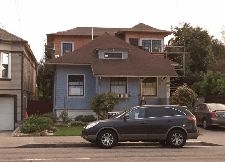 House with second-floor renovation underway, posted For Rent, and accessible parking indicating investment or rental potential.