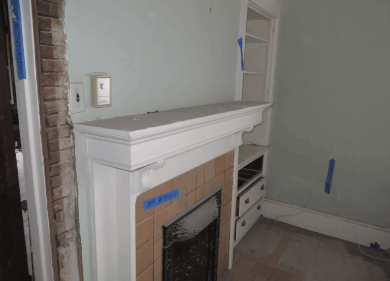 Fireplace mantel with tile surround, built-in shelving, and marked renovation zones indicating areas for structural updates.