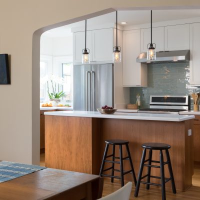 Modern Berkeley kitchen with open layout, updated appliances, central island, ample storage, and dining area connectivity.