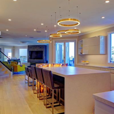 Contemporary kitchen with spacious island and open floor plan seamlessly merging with living area, ideal for renovation potential.