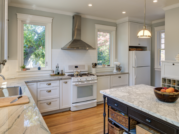 Kitchen features updated layout, high-end appliances, and preserved architectural elements, blending historic value with efficiency.