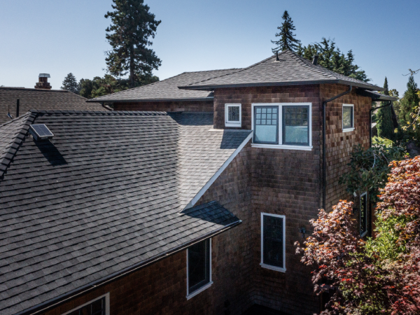 A multi-story house with updated windows demonstrates a high-quality historical renovation, featuring enhanced structural integrity.