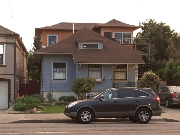 House with second-floor renovation underway, posted For Rent, and accessible parking indicating investment or rental potential.