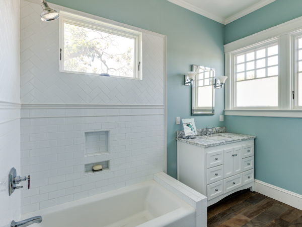 Bathroom featuring original window placement, modernized fixtures, high-quality finishes, and updated plumbing—ideal for redevelopment.