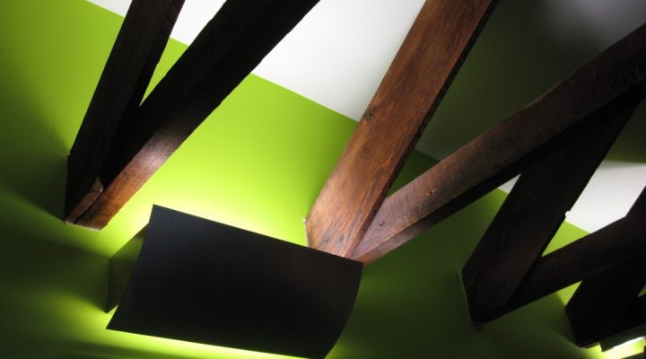 Exposed wooden ceiling beams and updated lighting show structural appeal and modern upgrades suitable for redevelopment projects.